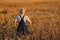 Portrait of senior farmer agronomist in wheat field checking crops before harvest. Successful organic food production and