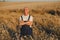 Portrait of senior farmer agronomist in wheat field checking crops before harvest. Successful organic food production and