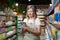 Portrait of senior female consultant, employee in grocery store, supermarket. Stands with a tablet, accepts the goods, checks. In