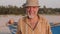 Portrait of senior fisherman in hat near his fishing boat - Sicily