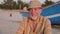 Portrait of senior fisherman in hat near his fishing boat - Sicily