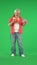 Portrait of senior hipster on Chroma key green screen background, man talking by video call on tablet, drinking