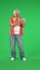 Portrait of senior hipster on Chroma key green screen background, man watching funny videos online on tablet