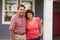 Portrait Of Senior Hispanic Couple Standing Outside House