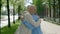 Portrait of a senior loving couple smiling outside in an urban street and hugging each other on the blurred background