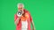 Portrait of senior man hipster on Chroma key green screen background, man talking in megaphone at the camera