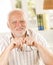 Portrait of senior man holding glasses