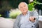 Portrait Of Senior Man Holding Metal Cane