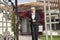 Portrait of a senior real estate agent walking with clipboard in front of house