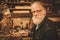 Portrait of senior restorer in his workshop