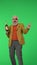 Portrait of senior stylish hipster on Chroma key green screen background, elegant man holding bottle of champagne