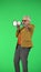 Portrait of senior stylish hipster on Chroma key green screen background, man talking in megaphone acting cool