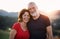 Portrait of senior tourist couple hikers standing in nature, looking at camera.