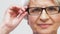 Portrait of senior woman adjusting her glasses