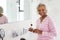 Portrait Of Senior Woman In Bathroom Putting On Make Up