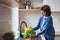 A portrait of senior woman indoors at home, washing lettuce.