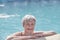 Portrait of senior woman in outdoor thermal swimming pool.