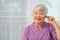 Portrait of a senior woman smile looking through magnifying glass, enlarged eye