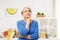 Portrait of senior woman thinking in kitchen