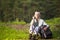 Portrait of Senior Woman With Tourist Backpack Dreaming in Forest Outdoors On Nature Background