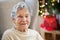 A portrait of a senior woman in wheelchair at home at Christmas time.