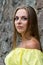Portrait of sensual fashionable young woman in yellow dress outdoor