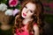 Portrait of a sensual redheaded girls on floral background