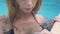 Portrait sensual woman in black bikini enjoying fresh water swimming pool in resort. Face attractive girl relaxing in