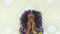 Portrait of a sensual young African woman looking at camera Pretty girl with afro hair touching her face. Beauty and