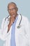 Portrait of a serious African American doctor with hand on chin over light blue background