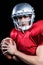 Portrait of serious American football player holding ball