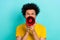 Portrait of serious angry guy with afro hairdo dressed yellow t-shirt loud scream in loudspeaker isolated on shine teal