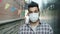 Portrait of serious Arab man wearing medical face mask standing outdoors in city