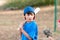 Portrait of serious baseball boy with wooden bat