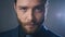 Portrait of serious business man with a beard looking at camera. Close-up of a confident boss in a black suit