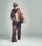 Portrait, serious and criminal cowboy in studio mockup, outlaw and wild west character with pistol. Overweight texas man