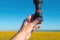 Portrait of serious farmer standing in front of center-pivot irrigation equipment in rapeseed field