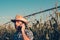 Portrait of serious farmer using mobile phone in corn field