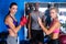 Portrait of serious female boxers by coach