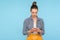 Portrait of serious focused woman with hair bun in fashionable outfit typing on smartphone, texting in social network