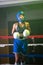 Portrait of serious girl in helmet and gloves on boxing ring