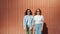 Portrait of serious girls standing outdoors in sunglasses looking at camera