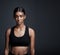 Portrait, serious and Indian woman with mockup, exercise and workout goal on dark studio background. Face, female person