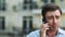 Portrait serious man having phone talk. Angry businessman talking on smartphone