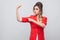 Portrait of serious proud beautiful business lady with hairstyle and makeup in red fancy blazer, standing, looking at camera and