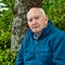 Portrait of Serious Senior Man Outdoors in Forest