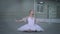 Portrait of serious slim agile ballerina sitting on floor moving bending. Wide shot concentrated Caucasian young