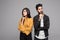 Portrait of serious thinking young loving indian couple isolated over gray background looking aside