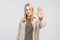 Portrait of a serious young blonde woman standing with outstretched hand showing stop gesture, permission denied