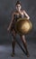 Portrait of a sexy amazon female posed with a sword,shield and a studio background.